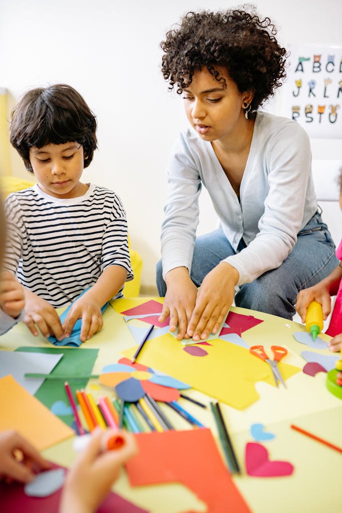 Child and teacher engaging in creative arts and crafts activities indoors.