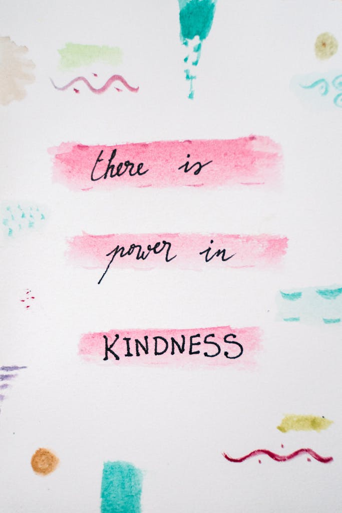 Motivational quote 'there is power in kindness' with colorful abstract design.