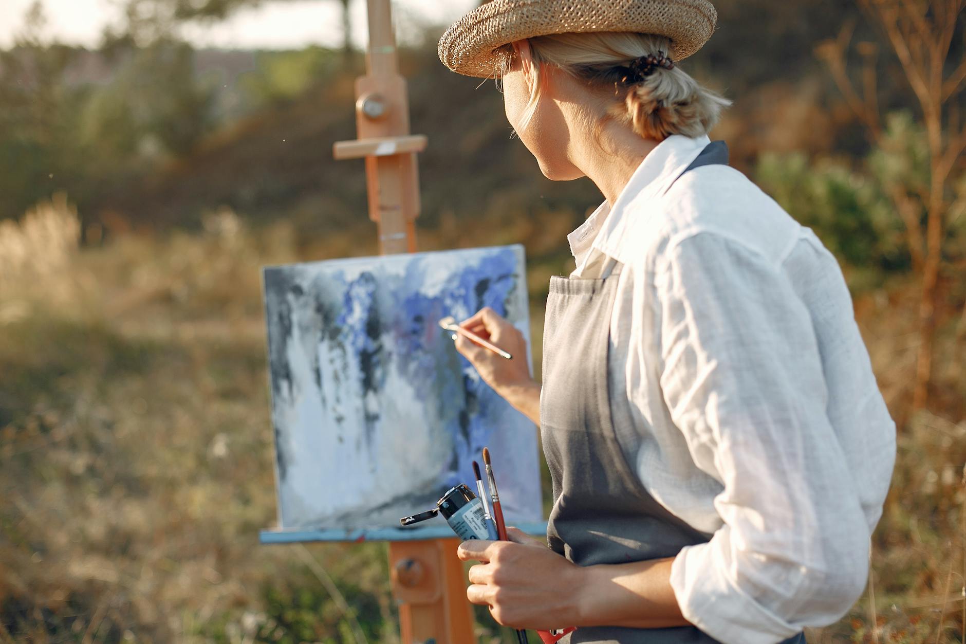 anonymous woman in hat zen painting in field